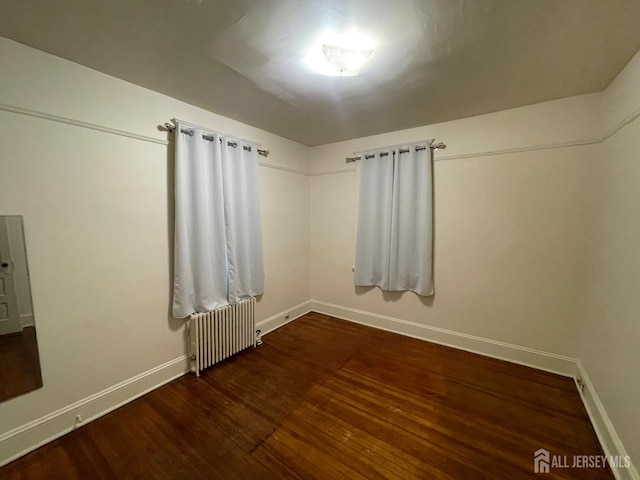 309 S 2nd Ave S, Highland Park, NJ 08904 - empty room featuring radiator heating unit, baseboards, and wood finished floors