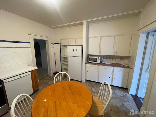 309 S 2nd Ave S, Highland Park, NJ 08904 - kitchen with white appliances, white cabinetry, and ornamental molding