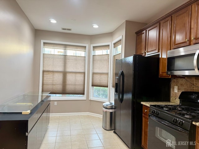 2116 Edward Stec Blvd, Edison, NJ 08837 - kitchen with stainless steel microwave, visible vents, a healthy amount of sunlight, and black gas range