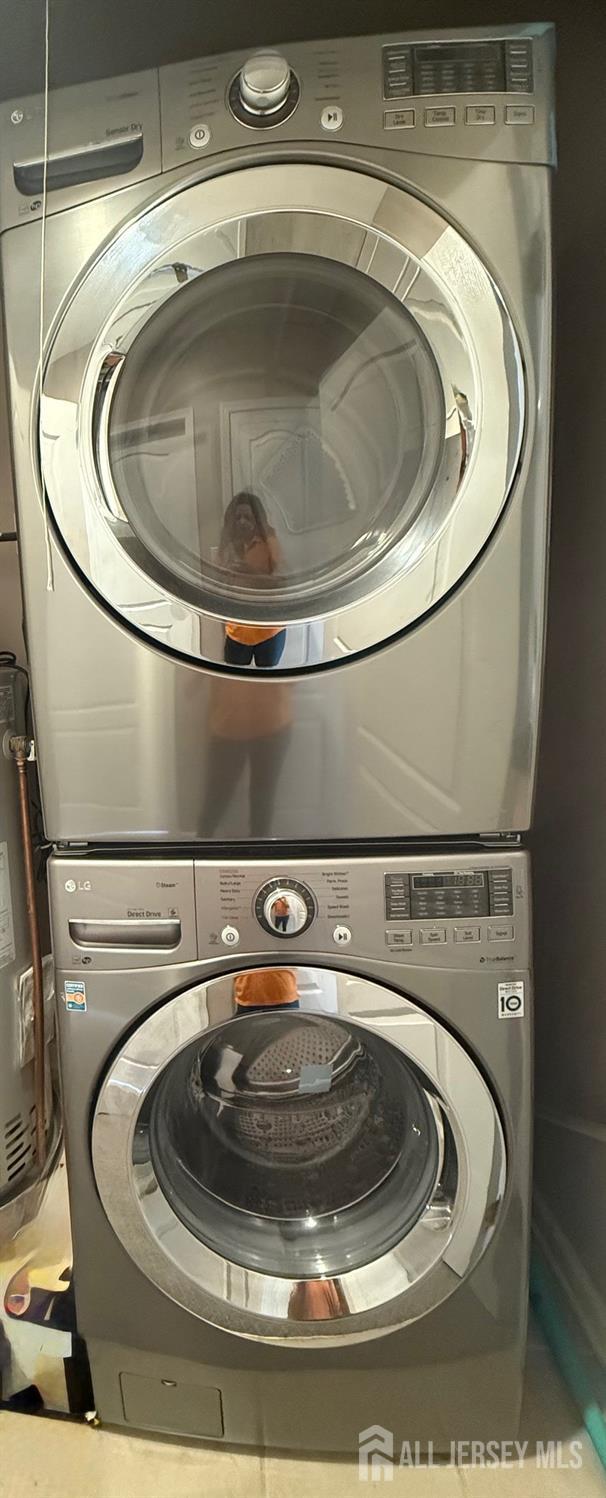 2116 Edward Stec Blvd, Edison, NJ 08837 - laundry room with water heater, stacked washer / drying machine, and laundry area