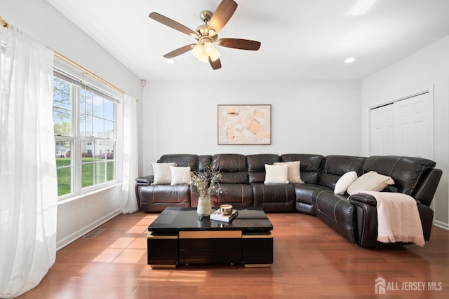 living room with baseboards, a ceiling fan, recessed lighting, and wood finished floors