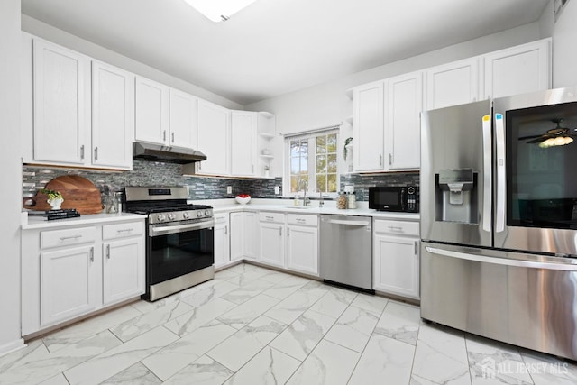 kitchen with open shelves, marble finish floor, light countertops, under cabinet range hood, and appliances with stainless steel finishes