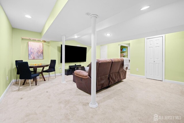 carpeted living area featuring baseboards, recessed lighting, and lofted ceiling