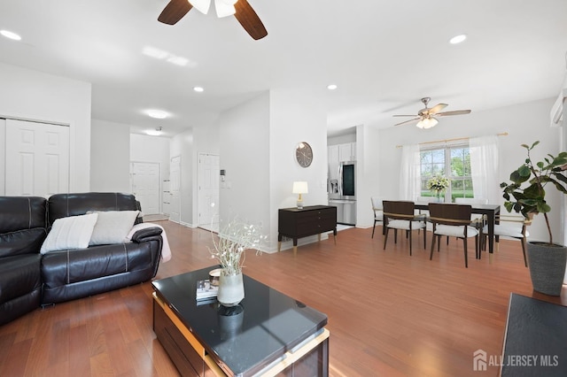 living area featuring recessed lighting, ceiling fan, and wood finished floors