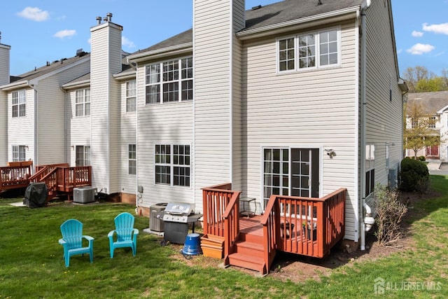 back of property featuring central air condition unit, a yard, a wooden deck, and a chimney