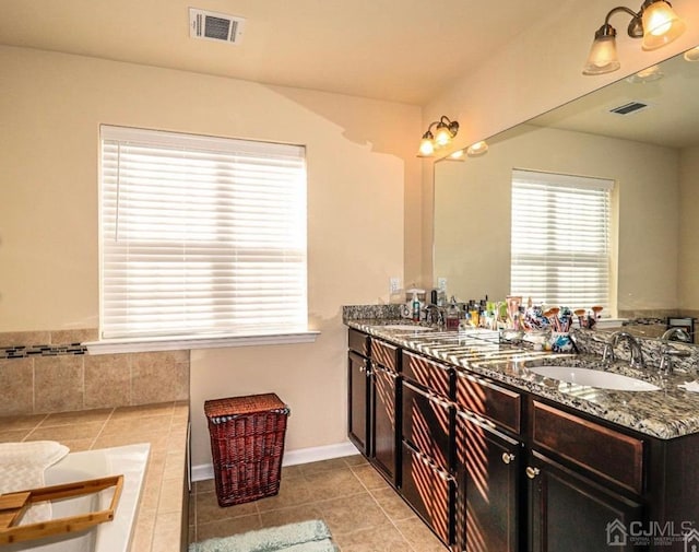 bathroom with vanity, tile patterned floors, and a bathtub