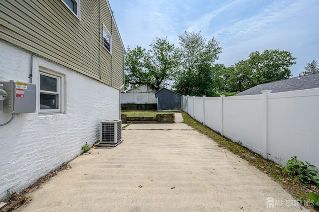 701 Beach Ave, Beachwood, NJ 08722 - fenced backyard featuring a storage unit and a patio