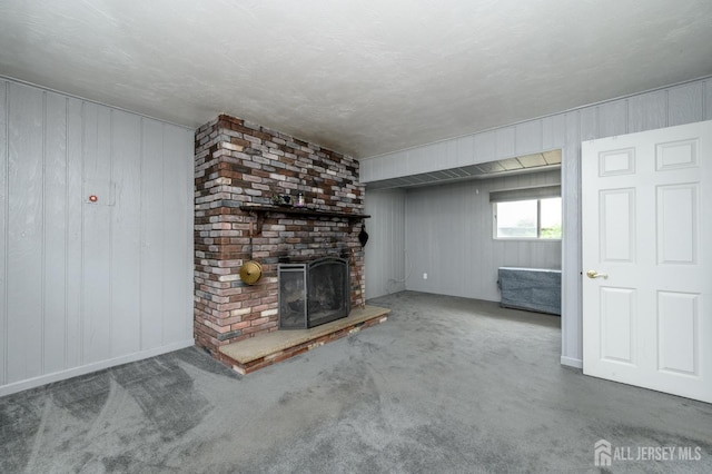 701 Beach Ave, Beachwood, NJ 08722 - unfurnished living room featuring a brick fireplace, carpet floors, and wooden walls
