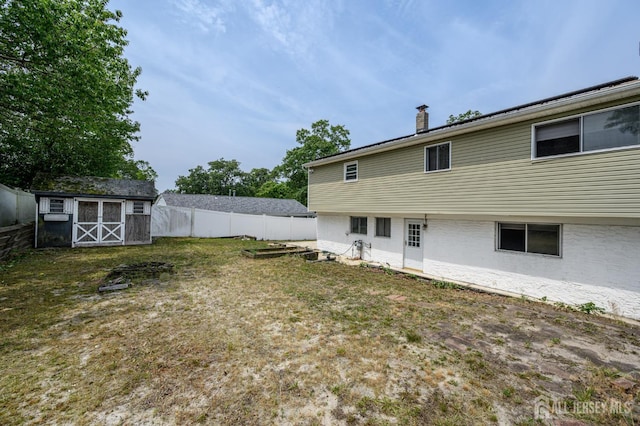 701 Beach Ave, Beachwood, NJ 08722 - rear view of property featuring a chimney and a storage shed