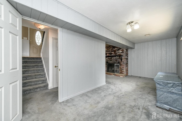 701 Beach Ave, Beachwood, NJ 08722 - below grade area with carpet flooring, stairs, a brick fireplace, and wooden walls