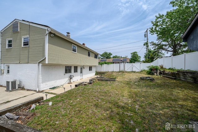 701 Beach Ave, Beachwood, NJ 08722 - fenced backyard featuring a vegetable garden and a patio area
