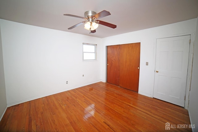 unfurnished bedroom with hardwood / wood-style floors and ceiling fan