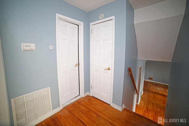 hallway with wood-type flooring