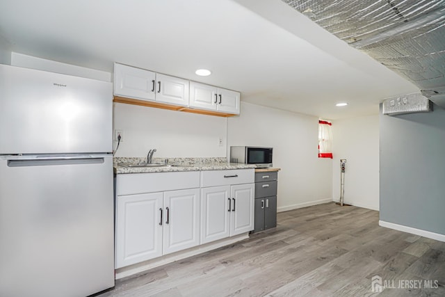 61 Trinity Ln, Woodbridge Proper, NJ 07095 - kitchen featuring stainless steel appliances, light wood finished floors, white cabinetry, recessed lighting, and light stone countertops
