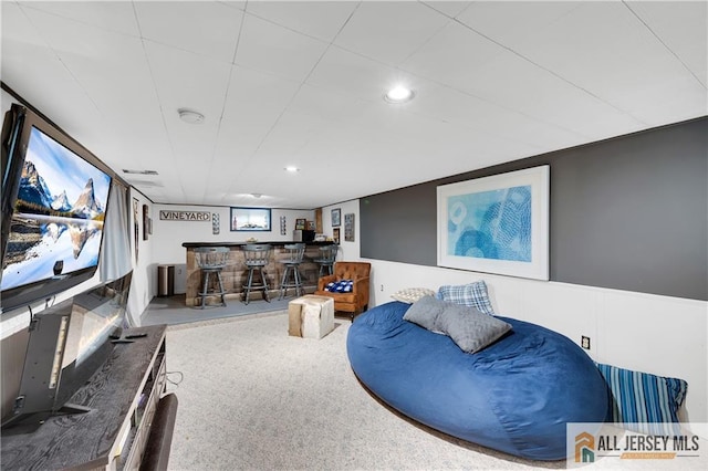 20 Karwatt Ct, Sayreville, NJ 08872 - carpeted living area with bar area, a wainscoted wall, and recessed lighting