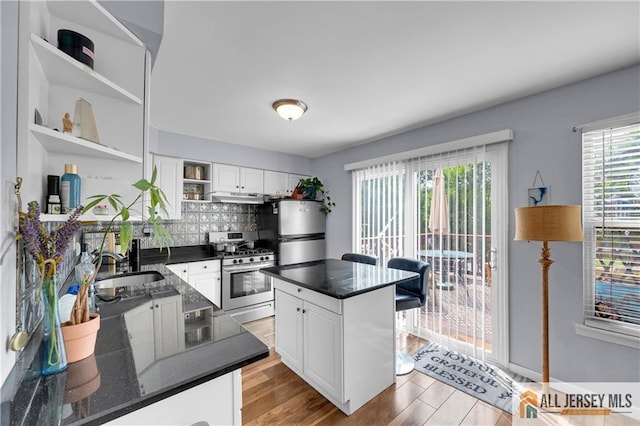 20 Karwatt Ct, Sayreville, NJ 08872 - kitchen featuring stainless steel range with gas stovetop, open shelves, refrigerator, and white cabinets