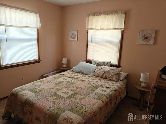 bedroom featuring dark carpet