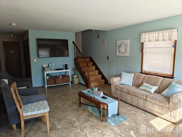 living room featuring stairway