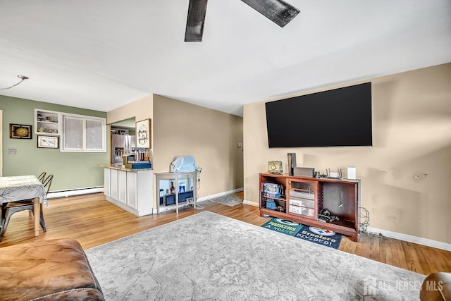 30 Falmouth Rd, Iselin, NJ 08830 - living room featuring baseboard heating, baseboards, wood finished floors, and a ceiling fan