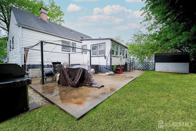 30 Falmouth Rd, Iselin, NJ 08830 - back of house featuring a patio, a yard, a chimney, and roof with shingles