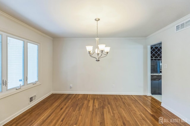 45 S Brook Dr, Milltown, NJ 08850 - empty room featuring wood finished floors, a chandelier, and ornamental molding