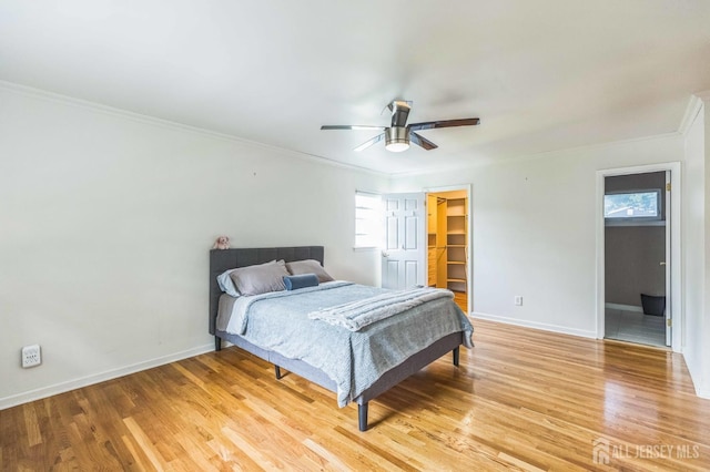 45 S Brook Dr, Milltown, NJ 08850 - bedroom featuring crown molding, multiple windows, light wood-type flooring, and a spacious closet