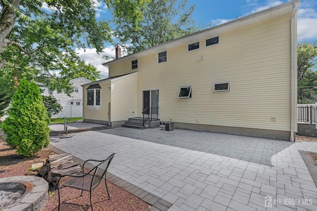 45 S Brook Dr, Milltown, NJ 08850 - rear view of property featuring a patio and a chimney