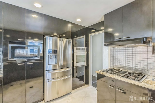 45 S Brook Dr, Milltown, NJ 08850 - kitchen featuring stainless steel appliances, backsplash, under cabinet range hood, light tile patterned floors, and light stone countertops