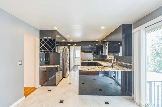 45 S Brook Dr, Milltown, NJ 08850 - kitchen featuring modern cabinets, decorative backsplash, light stone countertops, a peninsula, and recessed lighting