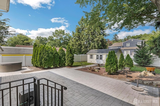 45 S Brook Dr, Milltown, NJ 08850 - fenced backyard featuring a hot tub, a patio, and an outdoor structure