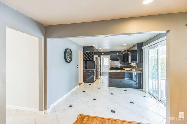 45 S Brook Dr, Milltown, NJ 08850 - kitchen with freestanding refrigerator, dark cabinetry, light tile patterned flooring, backsplash, and light stone countertops