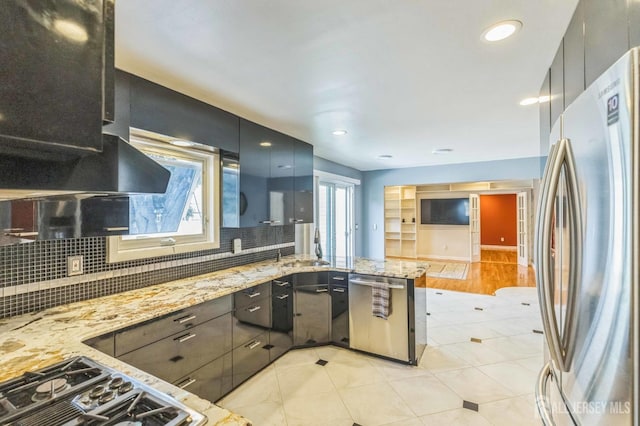 45 S Brook Dr, Milltown, NJ 08850 - kitchen with stainless steel appliances, ventilation hood, backsplash, a peninsula, and light stone counters
