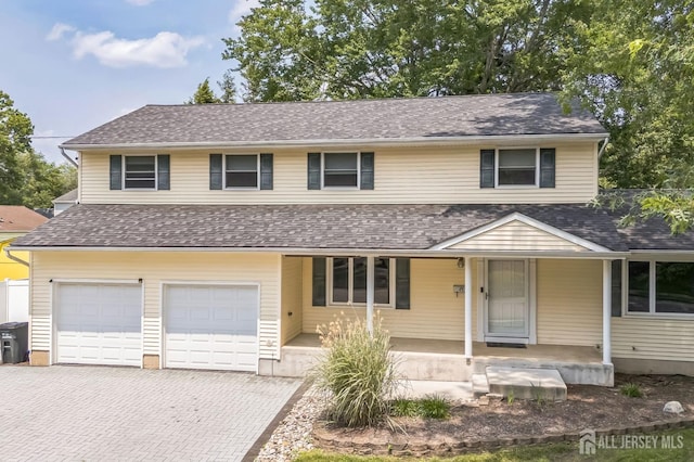 45 S Brook Dr, Milltown, NJ 08850 - view of front of property featuring a porch, an attached garage, decorative driveway, and a shingled roof