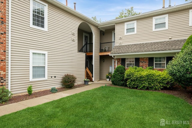 100 Neilly Ct, Old Bridge, NJ 08857 - view of front of home featuring a front yard, a balcony, and brick siding