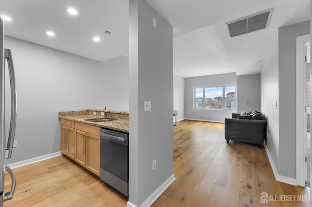 20 Livingston Ave Unit 905, New Brunswick, NJ 08901 - kitchen featuring stainless steel appliances, light wood-type flooring, open floor plan, light stone counters, and recessed lighting