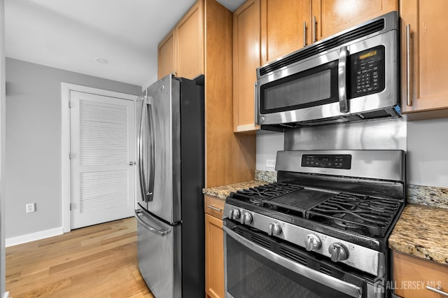 20 Livingston Ave Unit 905, New Brunswick, NJ 08901 - kitchen with appliances with stainless steel finishes, light wood-style floors, and light stone countertops