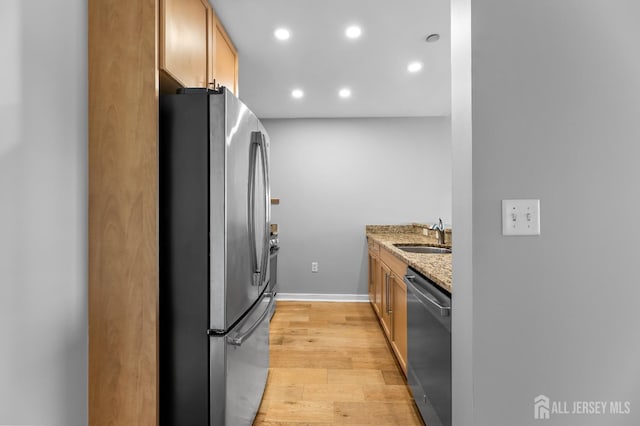 20 Livingston Ave Unit 905, New Brunswick, NJ 08901 - kitchen featuring appliances with stainless steel finishes, light wood-type flooring, light stone countertops, and recessed lighting