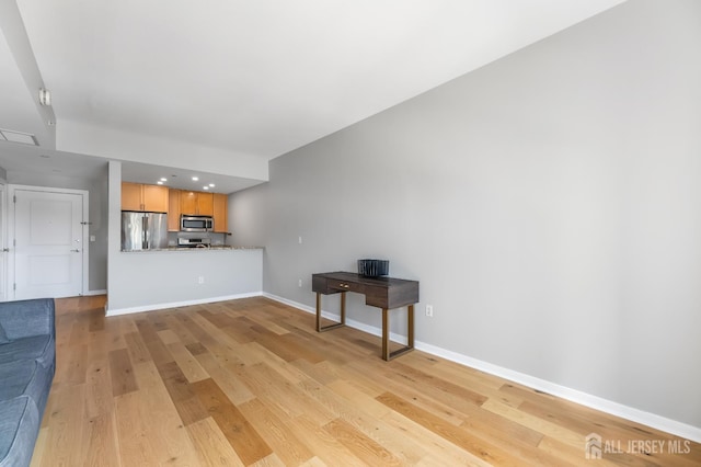 20 Livingston Ave Unit 905, New Brunswick, NJ 08901 - unfurnished living room featuring light wood-style floors and baseboards