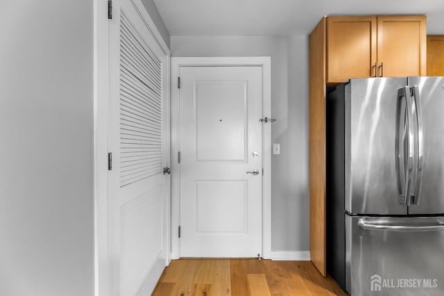 20 Livingston Ave Unit 905, New Brunswick, NJ 08901 - kitchen with freestanding refrigerator, light wood-style flooring, and brown cabinetry