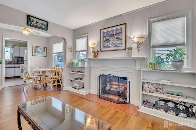436 2nd St, Dunellen, NJ 08812 - living room with a lit fireplace, ceiling fan, wood finished floors, and plenty of natural light