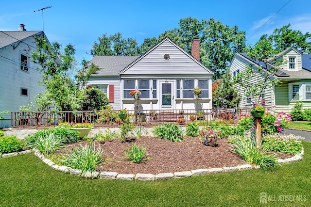 436 2nd St, Dunellen, NJ 08812 - view of front of house featuring a chimney and a sunroom