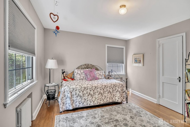 436 2nd St, Dunellen, NJ 08812 - bedroom with radiator and wood finished floors
