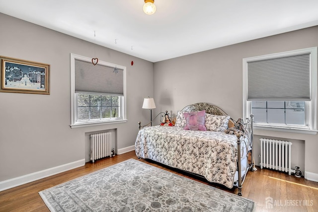436 2nd St, Dunellen, NJ 08812 - bedroom with radiator heating unit and wood finished floors