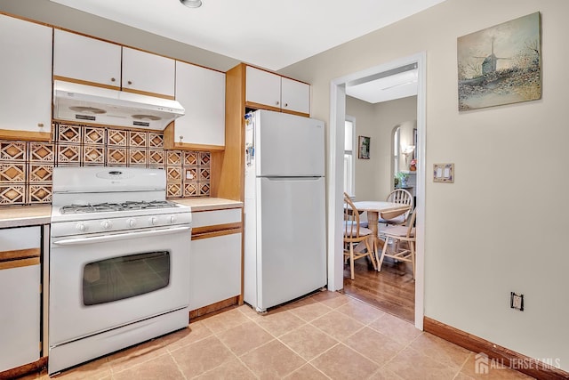 436 2nd St, Dunellen, NJ 08812 - kitchen featuring white appliances, exhaust hood, light countertops, white cabinets, and decorative backsplash