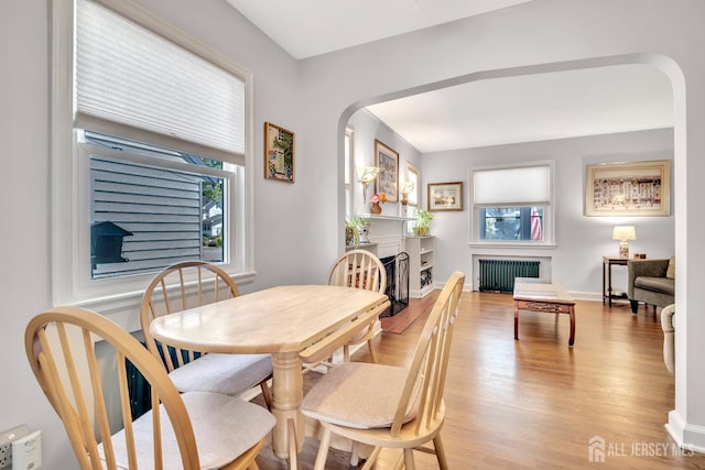 436 2nd St, Dunellen, NJ 08812 - dining room with radiator heating unit, healthy amount of natural light, and arched walkways