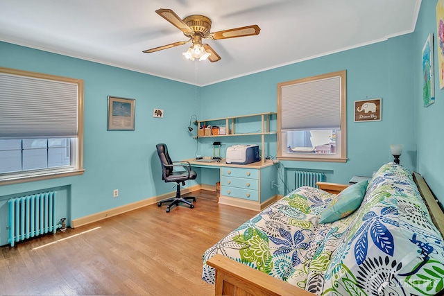 436 2nd St, Dunellen, NJ 08812 - bedroom featuring radiator, wood finished floors, crown molding, an office area, and ceiling fan
