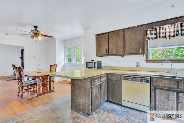 kitchen with sink, ceiling fan, dishwasher, kitchen peninsula, and light wood-type flooring