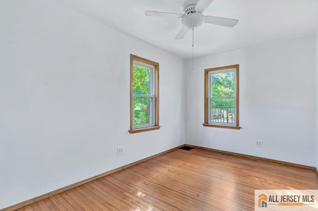 spare room with ceiling fan and light wood-type flooring