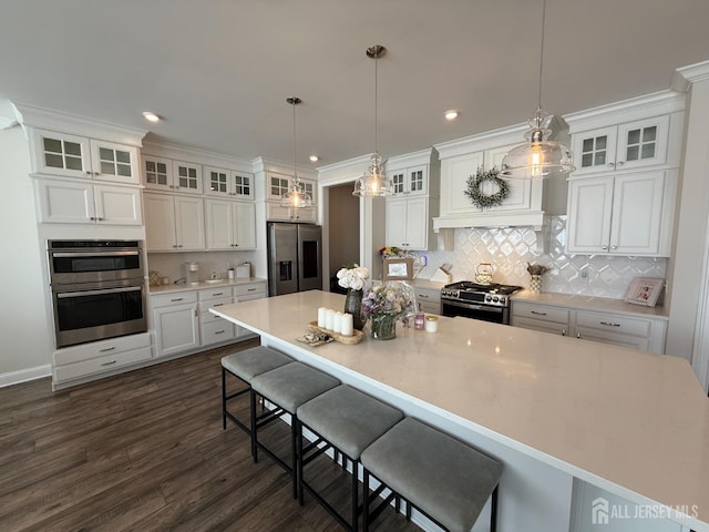 3504 Charleston Dr, Monroe, NJ 08831 - kitchen featuring stainless steel appliances, white cabinetry, decorative backsplash, a large island, and light countertops