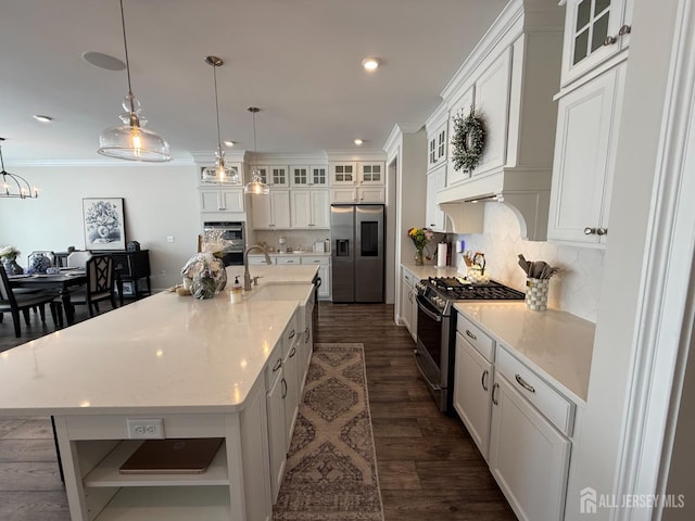 3504 Charleston Dr, Monroe, NJ 08831 - kitchen with stainless steel appliances, white cabinets, tasteful backsplash, a sink, and crown molding